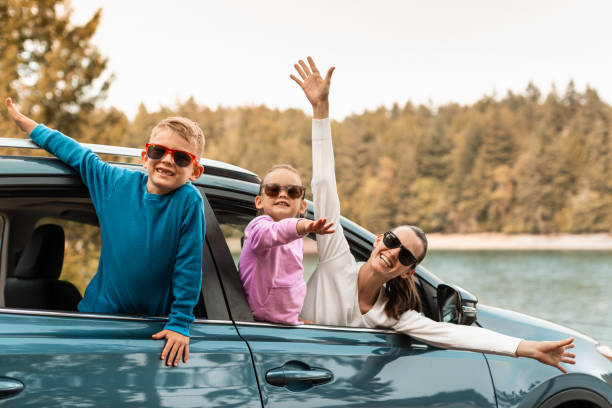 Mother, son and daughter getting ready for a road trip.